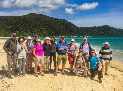 Tour group and guide on the beach at Abel Tasman National Park