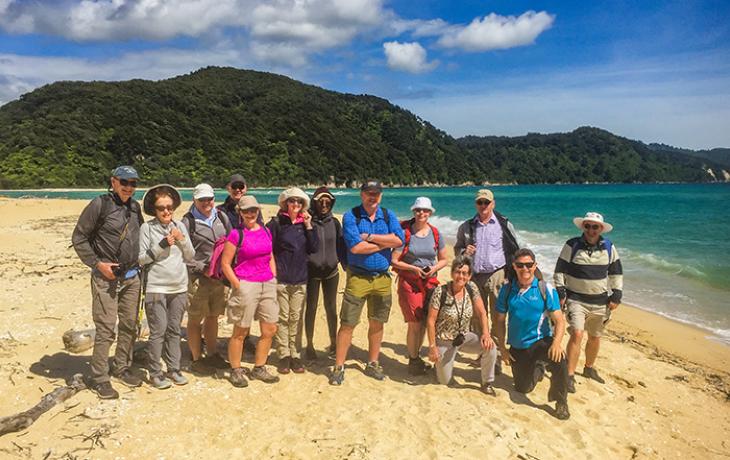 Tour group and guide on the beach at Abel Tasman National Park