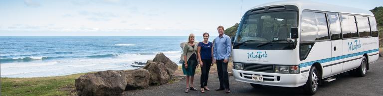 Ena, Miles and Alesha with the MoaTrek coach at Muriwai beach - All about MoaTrek