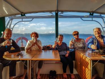 Enjoying hot drinks onboard while cruising Lake Rotoiti