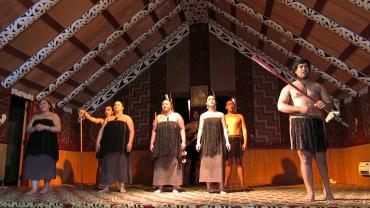 Maori performers in traditional meeting house - Maori Culture Tours NZ