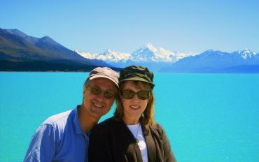 Happy couple at Lake Pukaki with Mt Cook in the distance - NZ North and South Island Itinerary