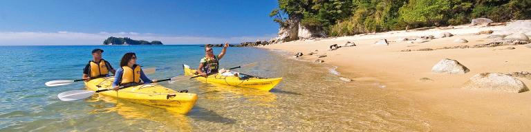 Kayakers near the golden sand beach, Abel Tasman National Park - NZ Itinerary Ideas