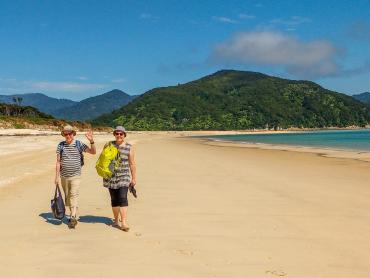 Senior travellers walking on the beach in Abel Tasman National Park