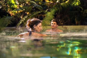 Relaxing in hot pools surrounded by rainforest in Franz Josef - Relaxing Tours of NZ