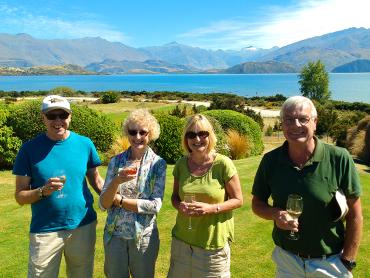 Senior travellers enjoying a glass of wine on the shores of Lake Wanaka